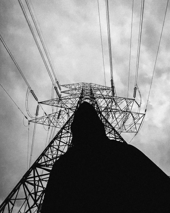 a black and white photo of an electricity tower, by Adam Marczyński, view from the ground, large)}], holding electricity, 1km tall