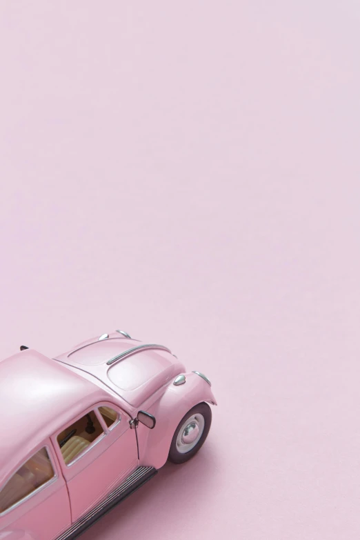 a pink toy car sitting on top of a pink surface, inspired by Otto Eckmann, trending on unsplash, 2 5 6 x 2 5 6, beetle, soft colors mono chromatic, 15081959 21121991 01012000 4k