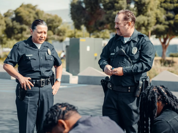 a group of police officers standing next to each other, unsplash, happening, danny trejo, male and female, calmly conversing 8k, schools