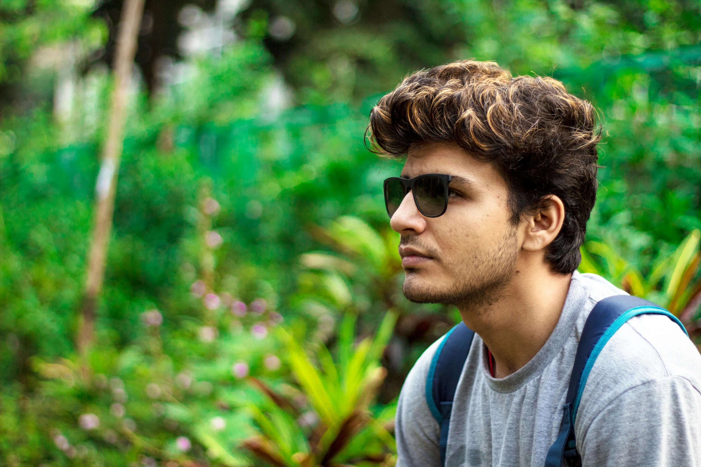 a close up of a person wearing a backpack, by Max Dauthendey, pexels contest winner, photorealism, beautiful young man, botanical garden, profile pic, vinayak