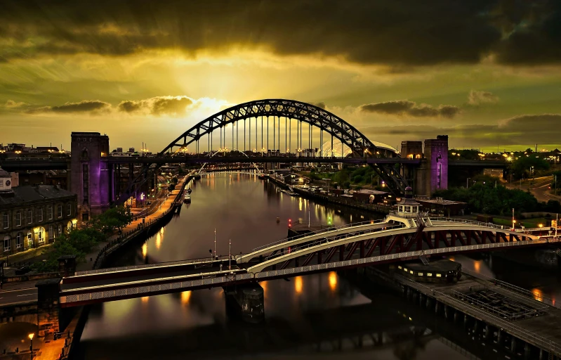 a bridge over a body of water under a cloudy sky, by Jay Hambidge, pexels contest winner, art nouveau, city sunset night, yorkshire, violet and yellow sunset, dramatic lighting - n 9