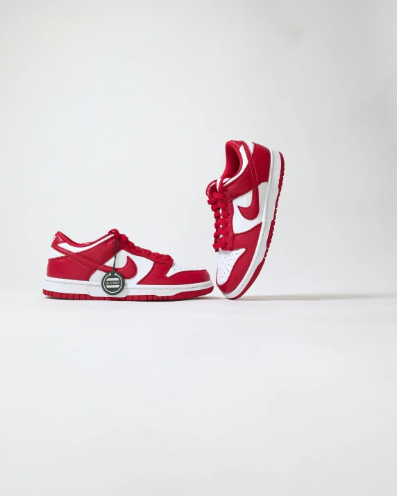 a pair of red and white sneakers on a white surface, by Ben Zoeller, hurufiyya, air shot, product introduction photo, smol, 6