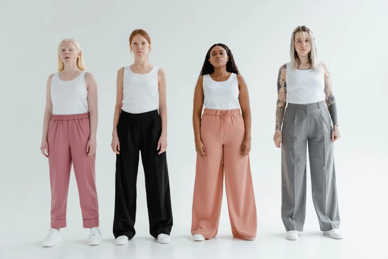 a group of women standing next to each other, by Carey Morris, trending on pexels, renaissance, large pants, healthcare, a full portrait of nordic female, grey