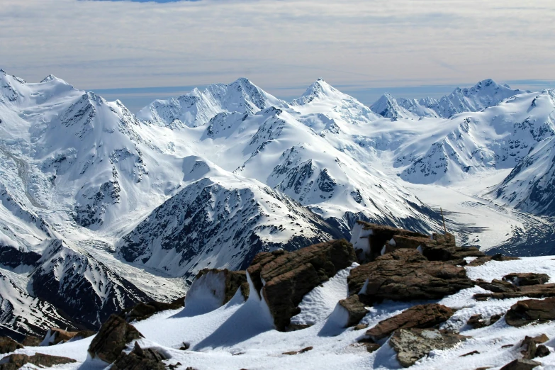 a man standing on top of a snow covered mountain, by Werner Andermatt, pexels contest winner, hurufiyya, snowy peaks, alaska, avatar image