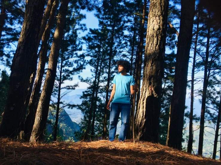 a man standing in the middle of a forest, pexels contest winner, happening, uttarakhand, avatar image, panoramic view of girl, arrendajo in avila pinewood