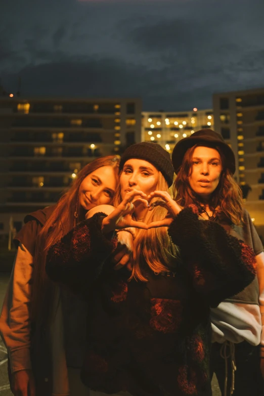 a group of women standing next to each other, an album cover, inspired by Elsa Bleda, unsplash, night view, hearts, teenage, headshot