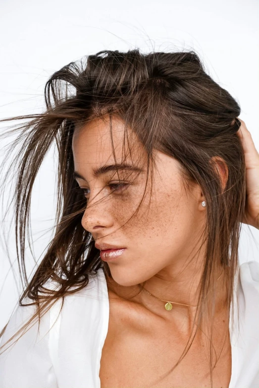 a woman with her hair blowing in the wind, trending on pexels, sparse freckles, tanned ameera al taweel, full product shot, scratching head