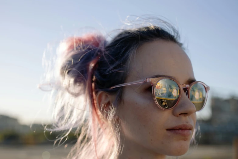 a close up of a person wearing sunglasses, by Emma Andijewska, trending on pexels, pink wispy hair, panoramic view of girl, polarized lens, girl with messy bun hairstyle