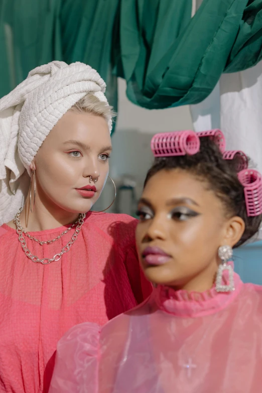 a couple of women standing next to each other, an album cover, inspired by Sophia Beale, trending on pexels, renaissance, shower cap, anya taylor - joy, pink crystal mohawk, hair loopies