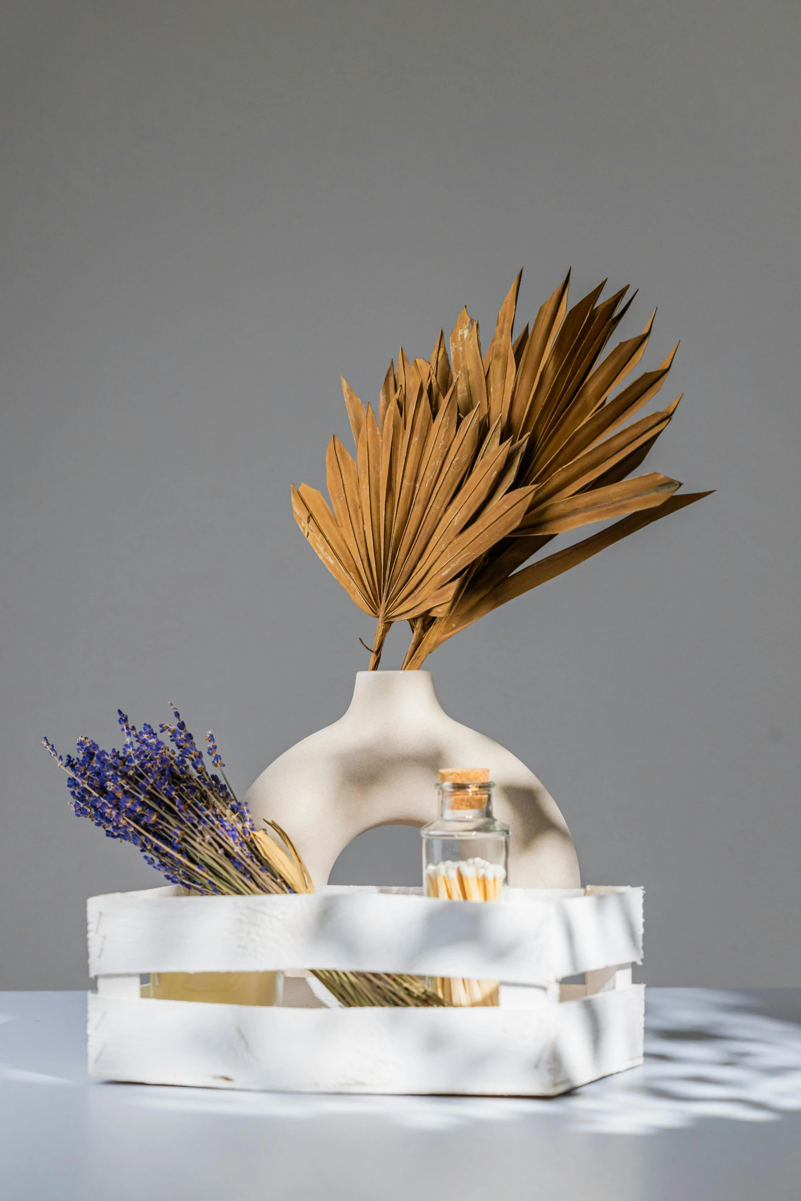 a white vase sitting on top of a white table, dried palmtrees, lavander and yellow color scheme, studio product shot, perfume bottle