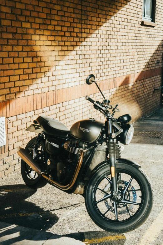 a motorcycle parked in front of a brick building, by Tom Bonson, pexels contest winner, triumph, it has six thrusters in the back, profile image, swift