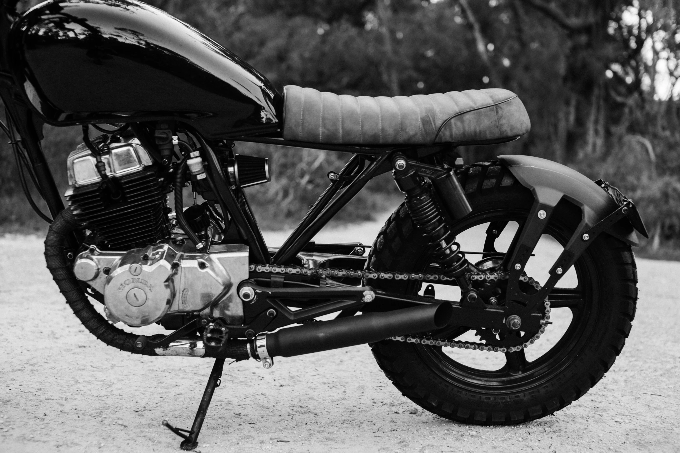 a black and white photo of a motorcycle, unsplash, dezeen, assembled, tx, gnarly details