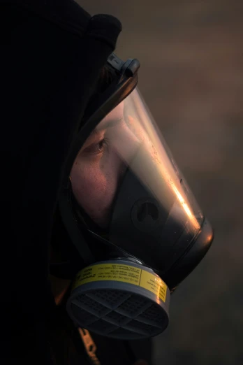 a man wearing a gas mask and a hood, natgeo, profile image, f / 2. 5, extreme close shot