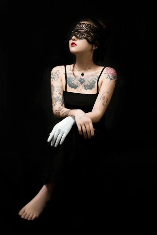 a woman with tattoos sitting on a chair, inspired by Elsa Bleda, pexels contest winner, bauhaus, black gloves, studio medium format photograph, concert, black main color