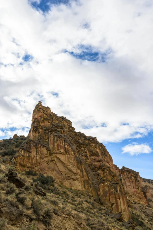 a group of people standing on the side of a mountain, red cloud, tall stone spires, black mesa, slide show