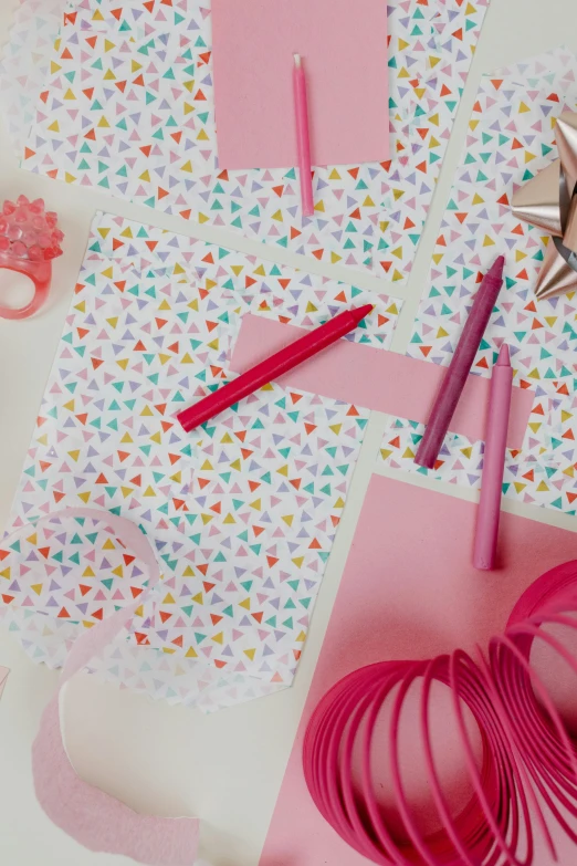 a variety of craft supplies laid out on a table, by Rachel Reckitt, party hats, geometric design, pink, hq print