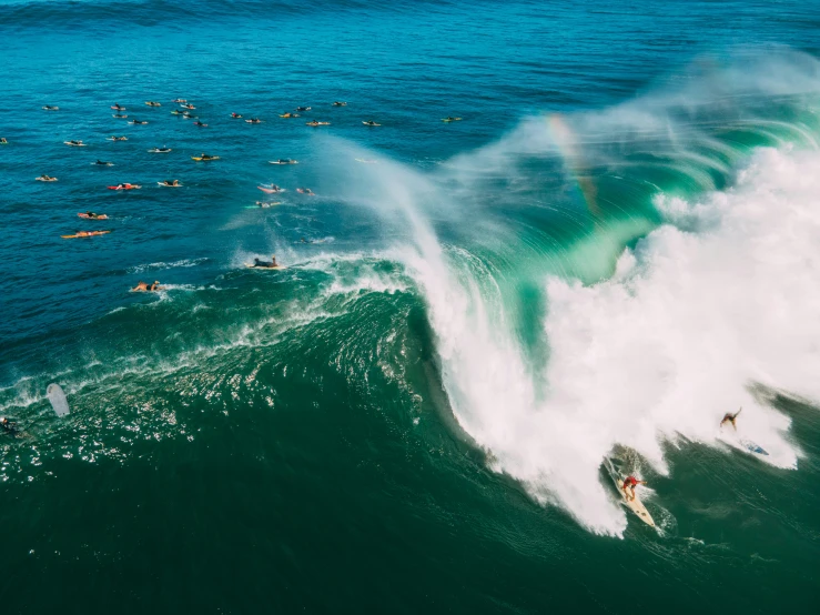 a man riding a wave on top of a surfboard, pexels contest winner, massive crowd, rainbow, bird's eye, lachlan bailey