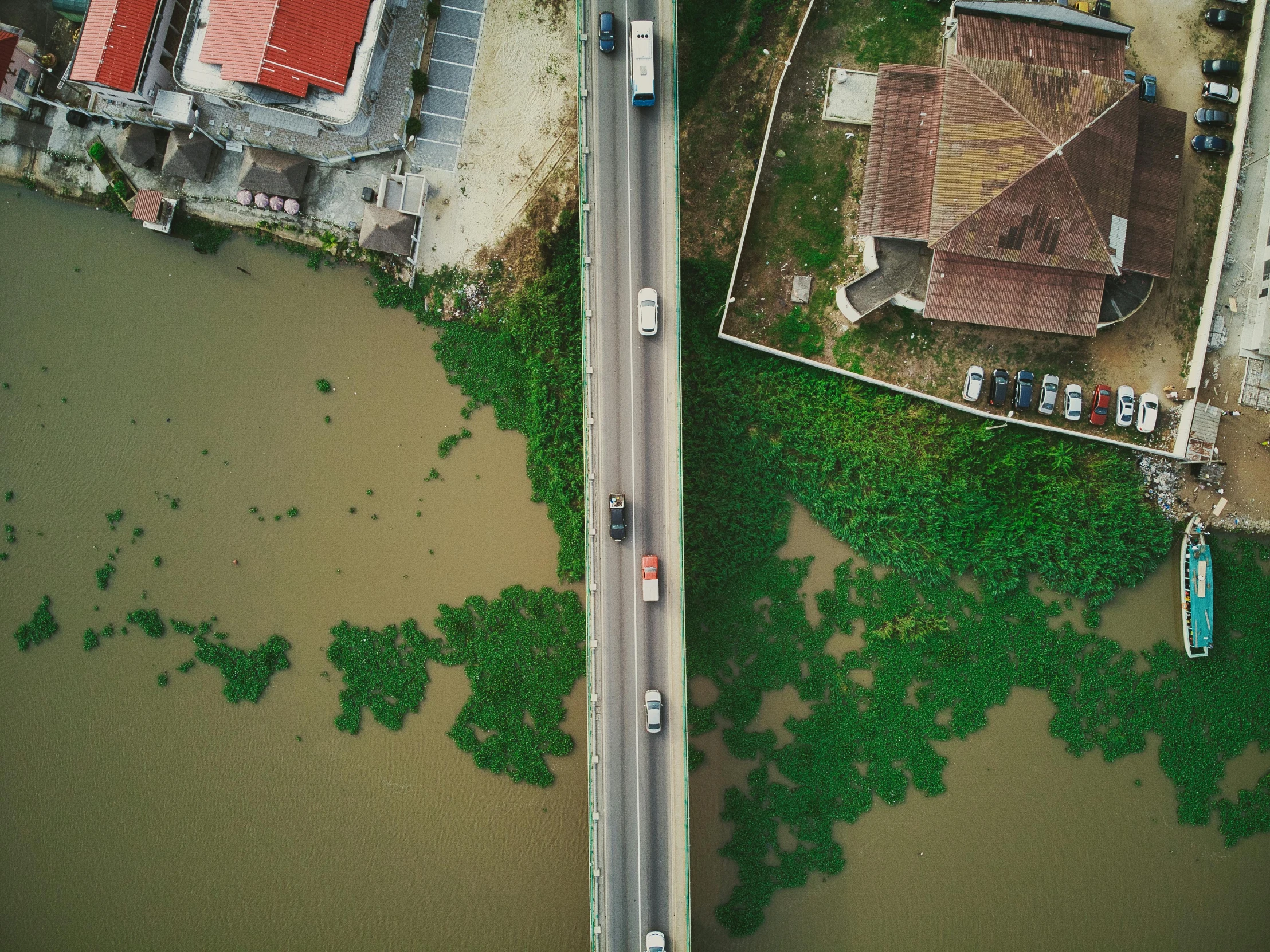 an aerial view of a road next to a body of water, pexels contest winner, photorealism, south jakarta, thumbnail, flood, bridge