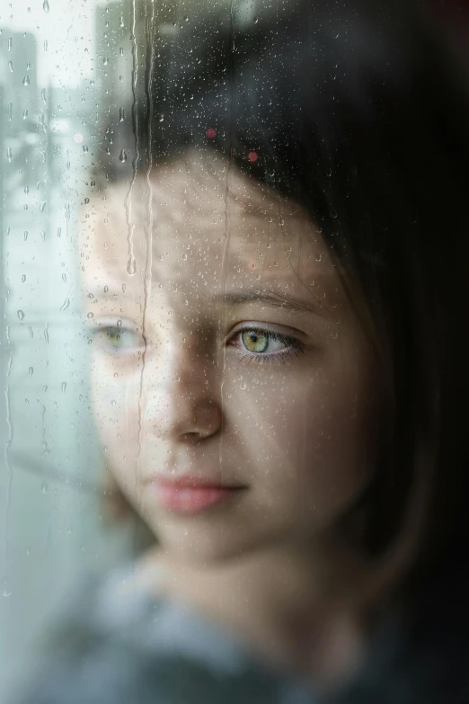 a close up of a person looking out a window, girl with white eyes, pouty face, raining, young child
