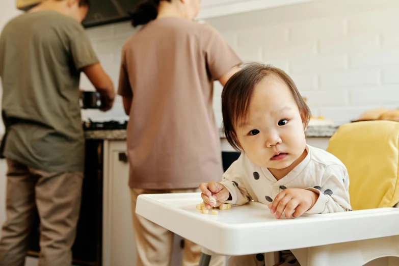 a baby sitting in a high chair in a kitchen, pexels contest winner, asian descent, carrying a tray, people sitting at tables, manuka