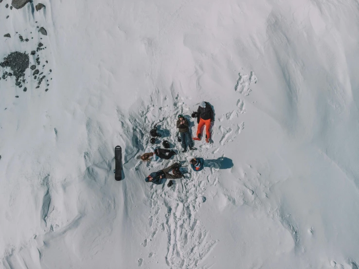 a group of people standing on top of a snow covered slope, pexels contest winner, figuration libre, [ overhead view of a table ]!!, inuit, powder, lightweight