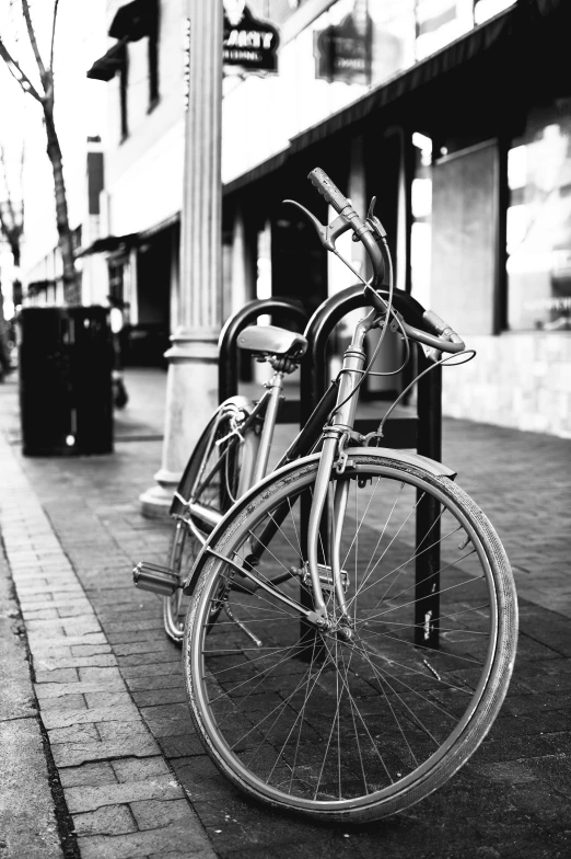 a black and white photo of a bicycle parked on a sidewalk, medium format film photography, large)}], in a square, :: morning