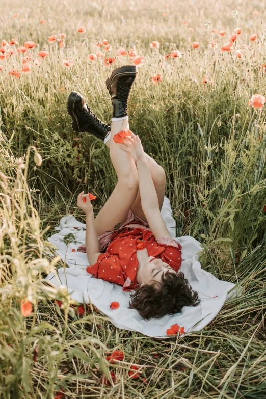 a woman laying on a blanket in a field of flowers, by Jessie Algie, pexels contest winner, red boots, flirting, calude monet style, doing a sassy pose