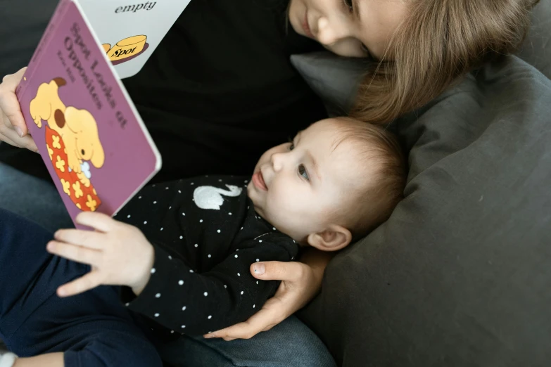 a woman reading a book to a baby, a portrait, pexels contest winner, avatar image, closeup - view, portrait image, thumbnail