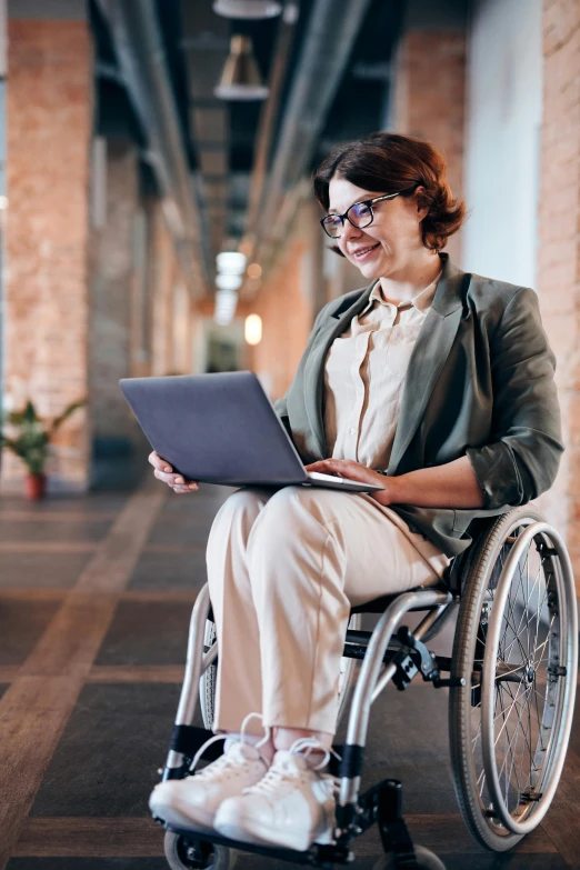 a woman in a wheelchair using a laptop, trending on pexels, renaissance, wearing jacket and skirt, university, proud looking, textured