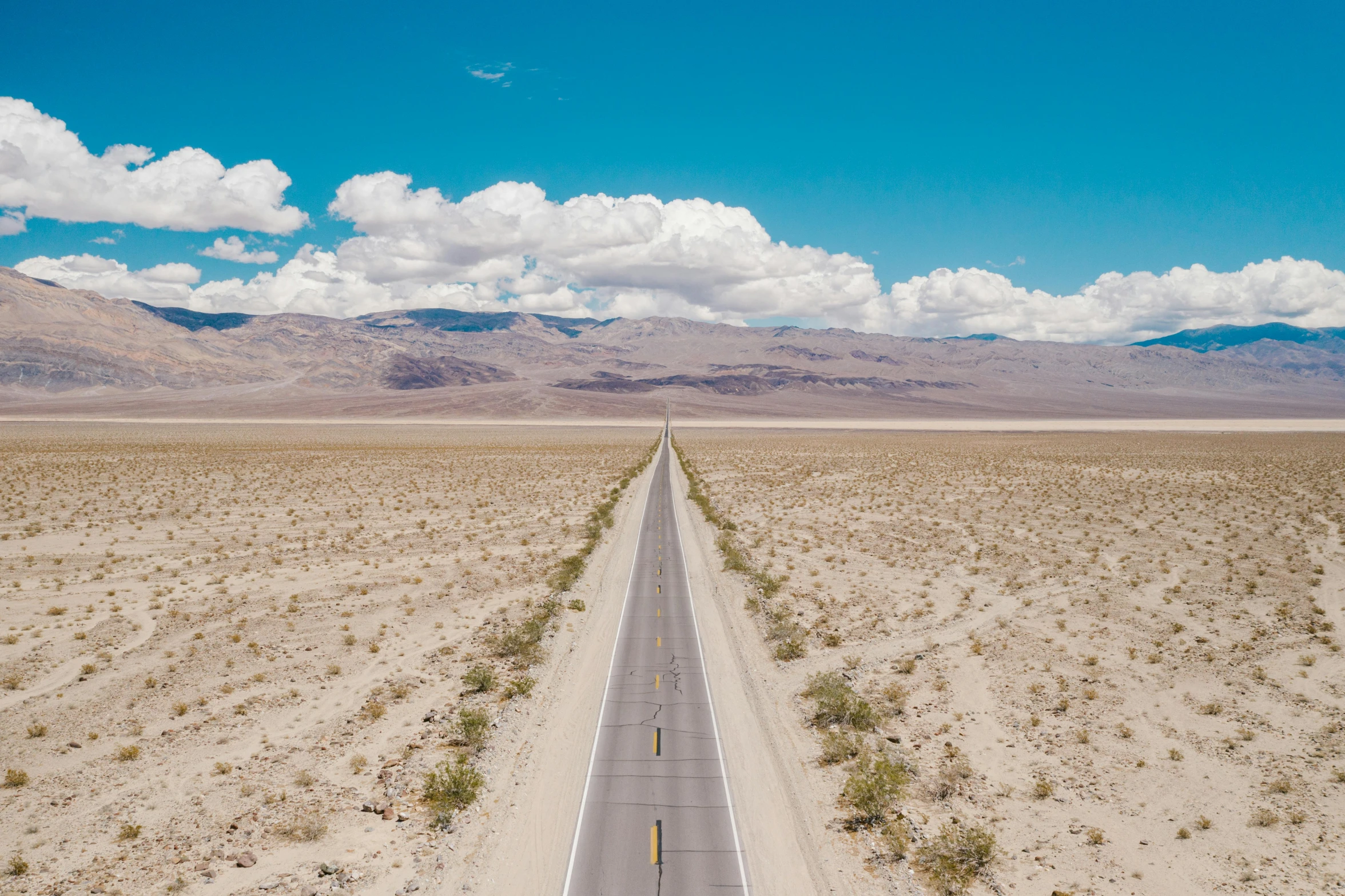 an empty road in the middle of the desert, by Whitney Sherman, unsplash contest winner, land art, background image, judy chicago, van, 2000s photo