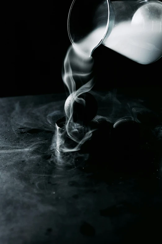 a person pouring milk into a glass on a table, a black and white photo, unsplash contest winner, process art, smoke swirls, cigar, on black paper, pot