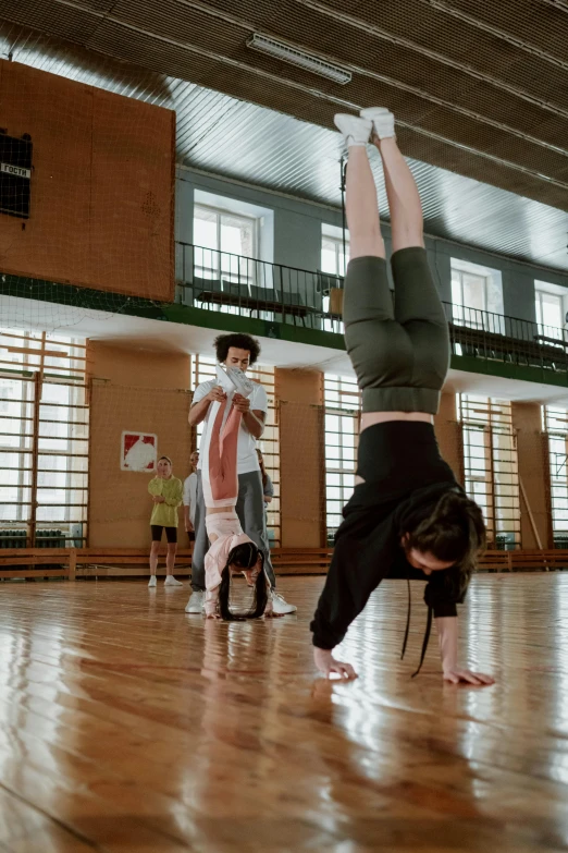 a group of people doing a handstand in a gym, by Adam Marczyński, square, high-quality photo, nadezhda tikhomirova, game ready