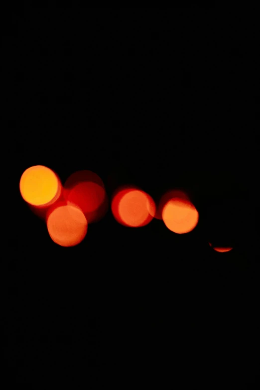 a blurry photo of some lights in the dark, an album cover, inspired by Jan Rustem, flickr, minimalism, dark oranges reds and yellows, dots abstract, 15081959 21121991 01012000 4k