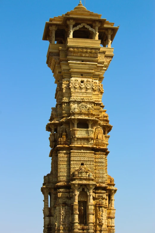 a tall tower with a clock on top of it, khajuraho, intricate detail?, very crisp details, yellow