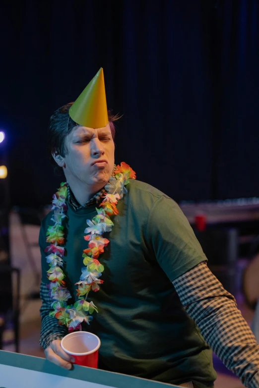 a man in a party hat playing ping pong, an album cover, by Ryan Pancoast, happening, exasperated, concert photo, in costume, caspar david