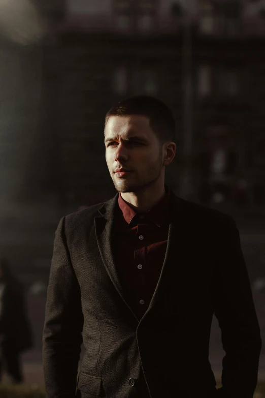 a man in a suit standing in front of a building, inspired by Niko Henrichon, diffuse cinematic lighting, **cinematic, a man wearing a black jacket, moody scene