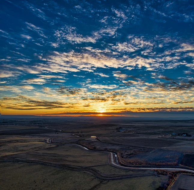 a bird's eye view of a beautiful sunset, by Arnie Swekel, unsplash contest winner, land art, plains, blue sky, 2 0 2 2 photo