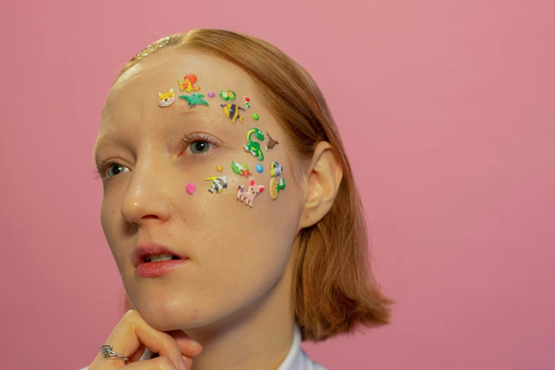 a close up of a person with glitter on their face, an album cover, by Fiona Rae, hyperrealism, stickers, porcelain holly herndon statue, portrait of maci holloway, multicoloured