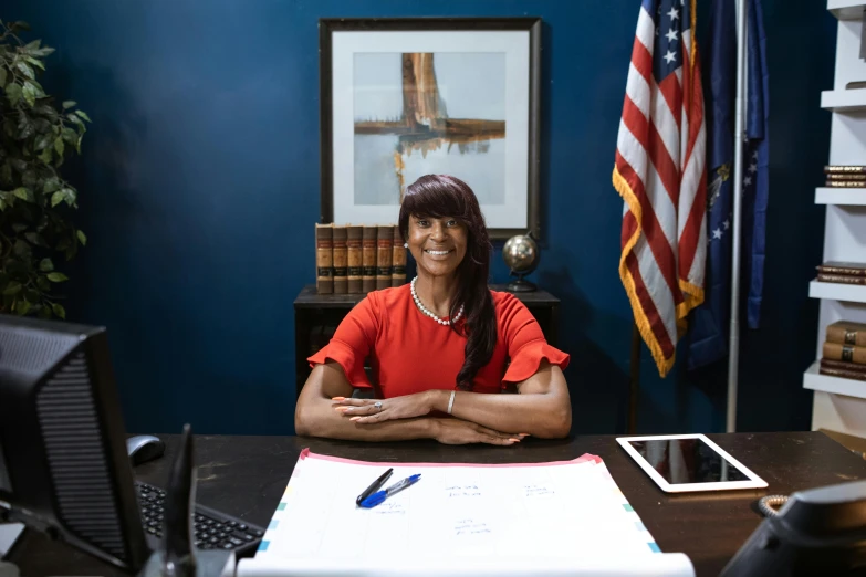 a woman sitting at a desk in an office, a portrait, by Everett Warner, pexels contest winner, inauguration, alexis franklin, official screenshot, senator armstrong