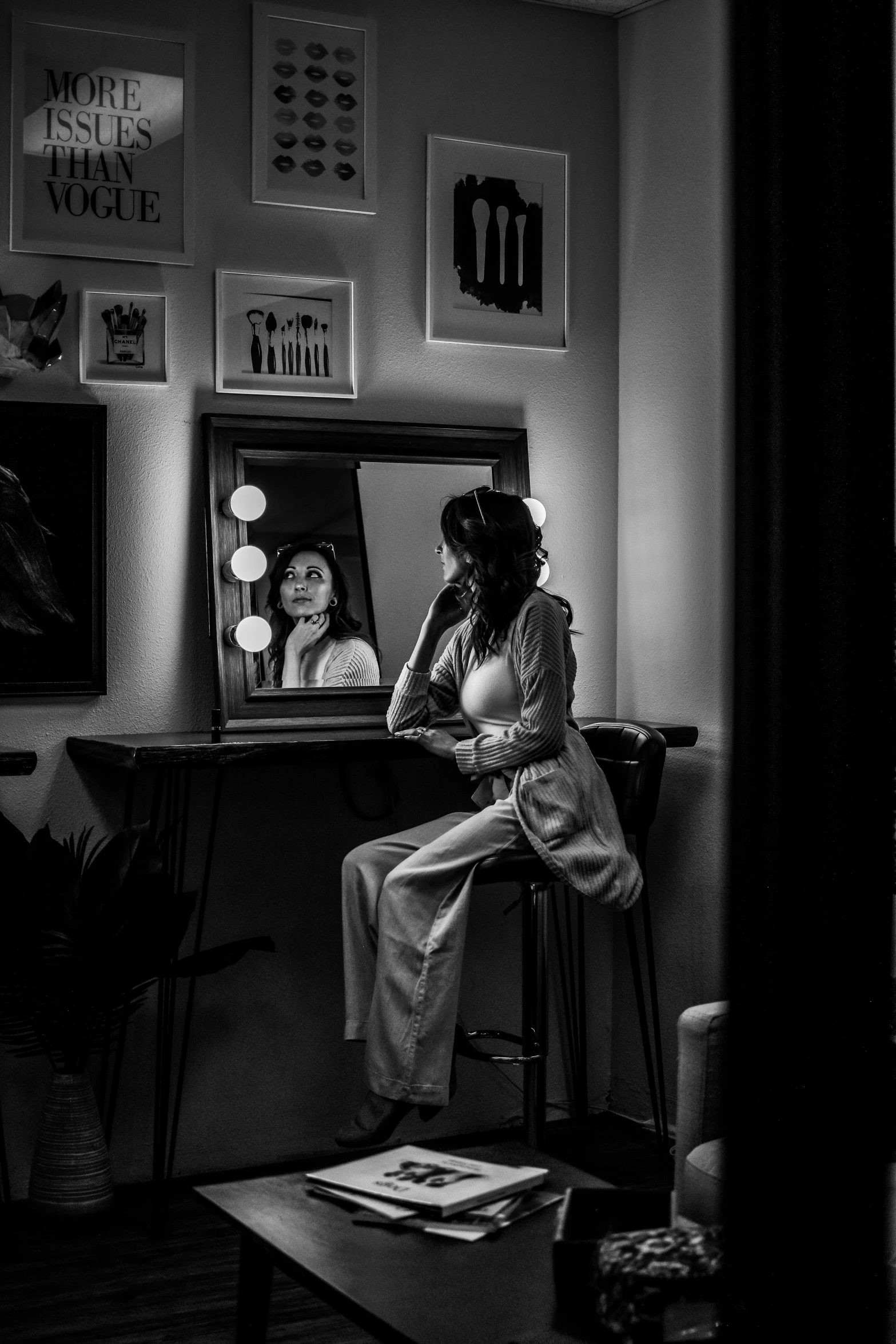 a woman sitting on a stool in front of a mirror, a black and white photo, pexels contest winner, photorealism, busy night, theater dressing room, photography alexey gurylev, at home