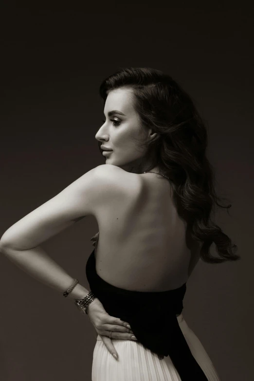 a black and white photo of a woman in a dress, inspired by George Hurrell, showing her shoulder from back, kat dennings, square, penelope cruz