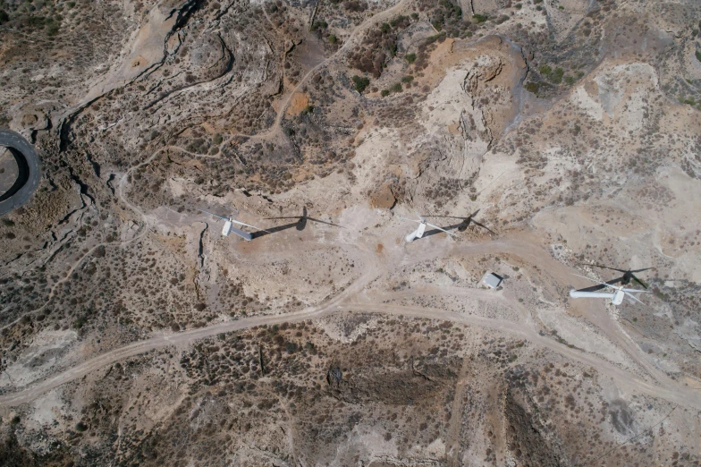 a group of airplanes sitting on top of a dirt field, a portrait, unsplash, les nabis, entrance to abandoned mine, satellite photo, cyprus, thumbnail