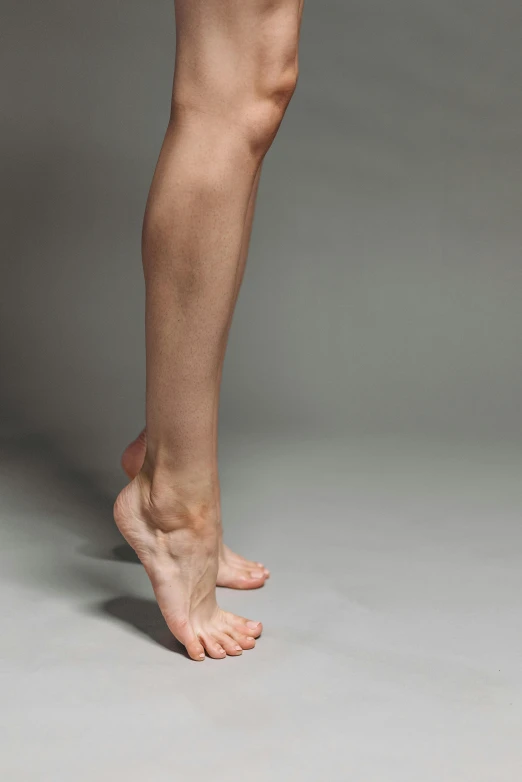 a woman holding a tennis racquet on top of a tennis court, inspired by Elizabeth Polunin, arabesque, veins merged feet head, on a gray background, uncropped, bare leg