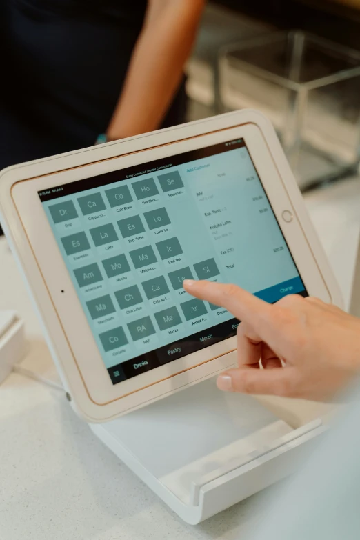 a close up of a person using a tablet, cash register, thumbnail, square, low quality photo