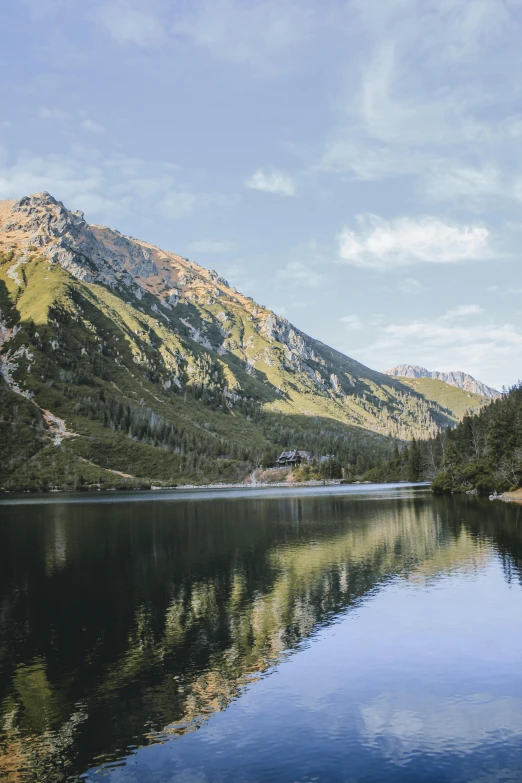 a body of water with mountains in the background, poland, whistler, multiple stories, single