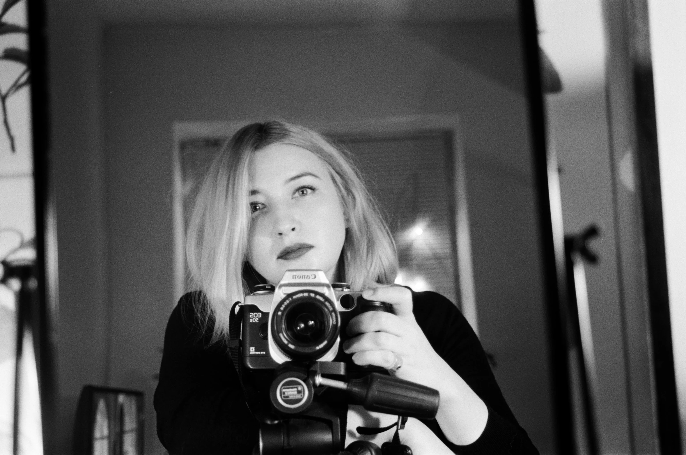 a woman taking a picture of herself in a mirror, a black and white photo, inspired by Vivian Maier, reddit, pop art, imogen poots, holding a big camera, brit marling style 3/4, ((portrait))