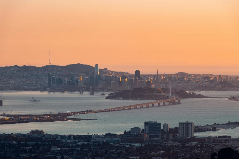 a view of a bridge over a large body of water, by Joseph Severn, pexels contest winner, overlooking sf from twin peaks, golden hour hues, shot on 1 5 0 mm, panorama