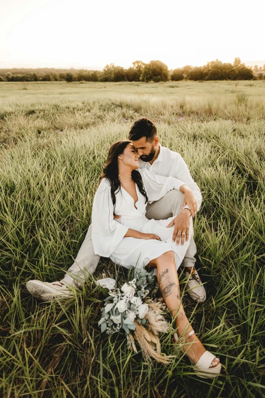 a man and woman sitting in a field, unsplash contest winner, romanticism, white, lush surroundings, instagram post, studio photo