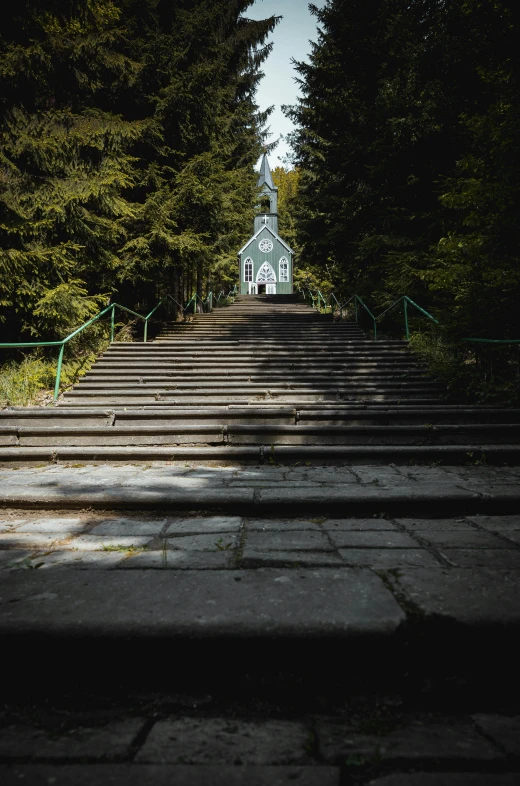 a set of stairs leading up to a church, by Ivan Grohar, unsplash, hideen village in the forest, low quality photo, marilyn church h