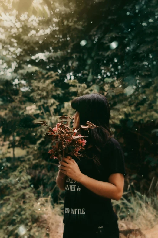 a woman holding a bunch of flowers in her hands, inspired by Elsa Bleda, pexels contest winner, with trees, a young asian woman, profile image, woman made of plants